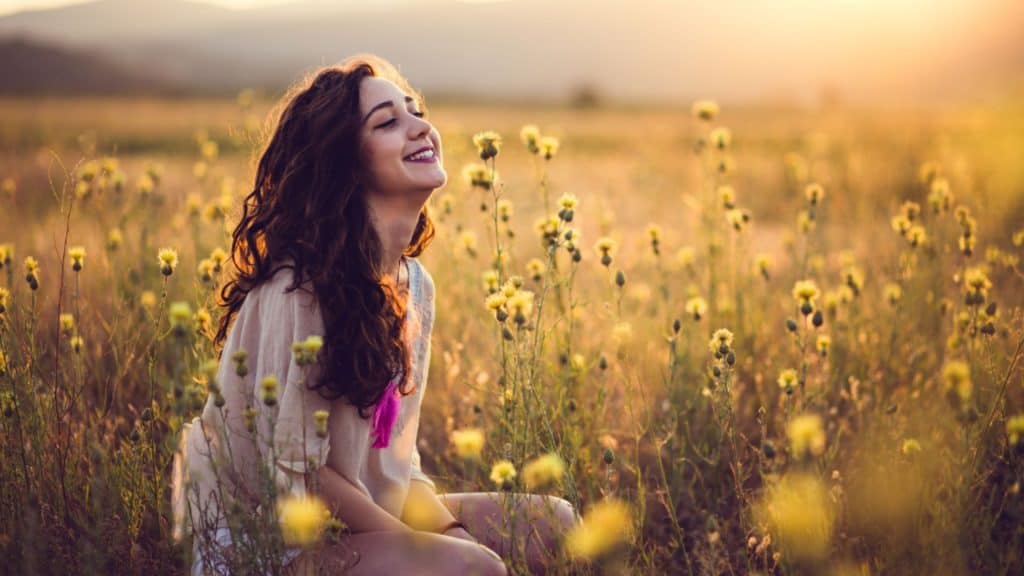 woman meditating in field